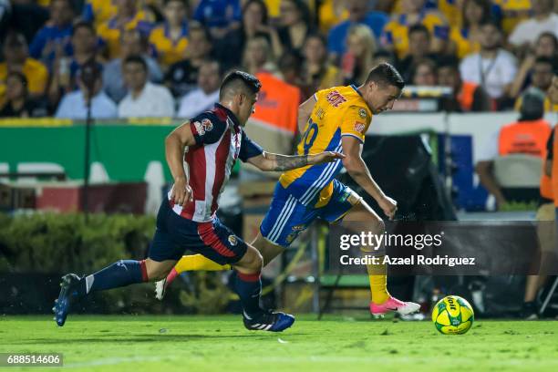 Jesus Duenas of Tigres fights for the ball with Michael Perez of Chivas during the Final first leg match between Tigres UANL and Chivas as part of...