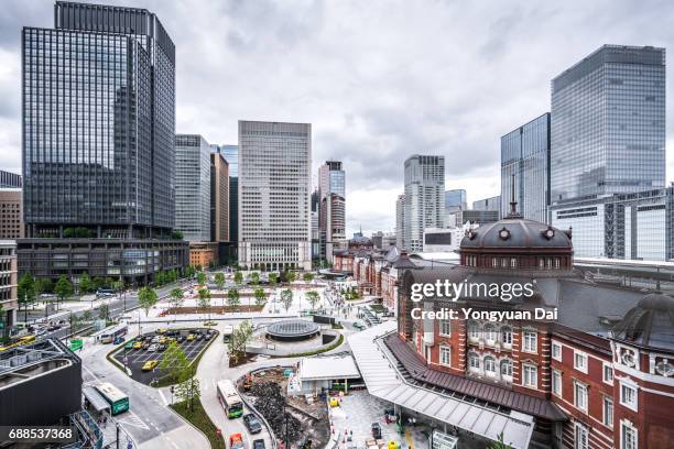 tokyo station and futuristic skyscrapers in marunouchi - tokyo station stock pictures, royalty-free photos & images