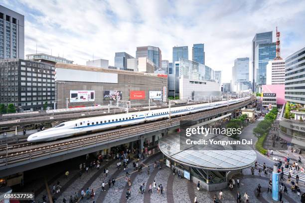 tokaido shinkansen bullet train riding through downtown tokyo - bullet speeding stock pictures, royalty-free photos & images