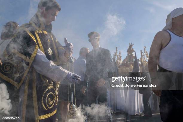 During the Easter week, processions with the image of Christ and the virgin Mary parade around Seville. Monaguillos priest, police and penitents...