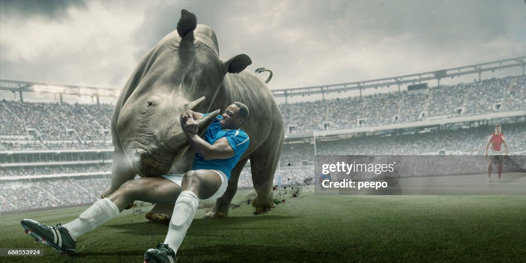 Rugby Player Tackling Rhino During Match in Outdoor Stadium