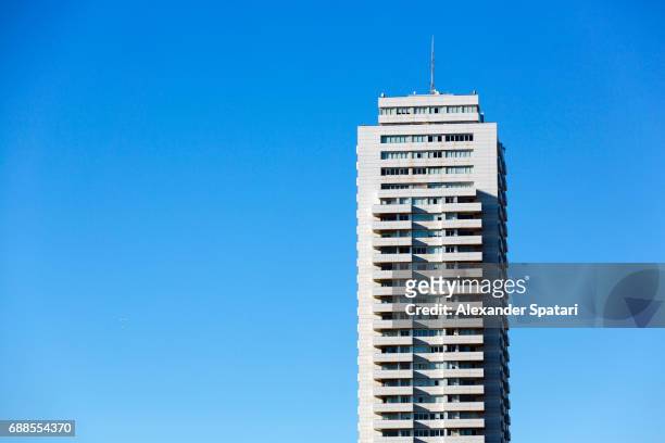 high rise building against clear blue sky - skyscraper stock pictures, royalty-free photos & images