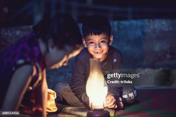 boy and girl studying in oil lamp - clapper board house stock pictures, royalty-free photos & images