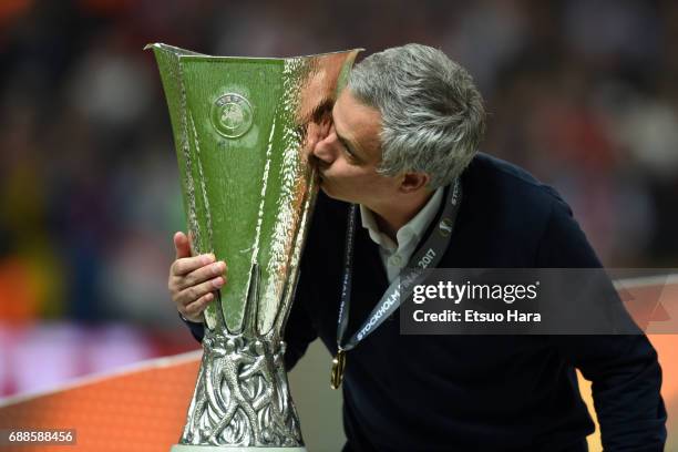 Manchester United manager Jose Mourinho kisses the trophy to celebrate after the UEFA Europa League final match between Ajax and Manchester United at...