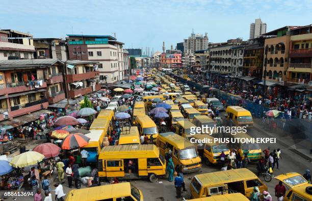 Public transport minibuses painted in bright yellow colour popularly called "Danfo" barricade the roads in search of passengers and causing traffic...