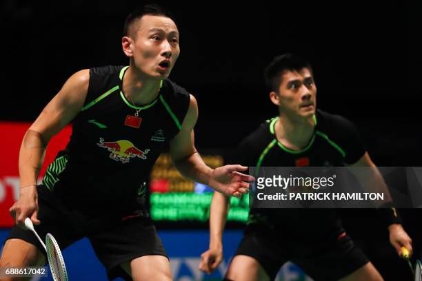 Fu Haifeng and partner Zhang Nan of China look across the net during their men's doubles Sudirman Cup badminton match against India's Satwiksairaj...