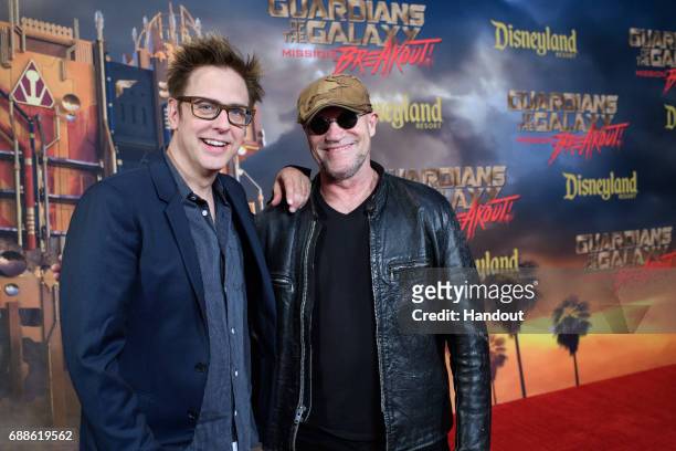 In this handout photo provided by Disney Resorts, director James Gunn and actor Michael Rooker attend the grand opening of Guardians of The Galaxy -...