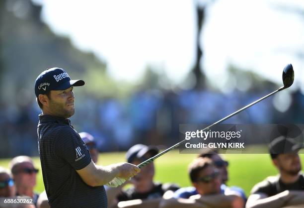 South African golfer Branden Grace watches his drive from the third tee on the second day of the golf PGA Championship at Wentworth Golf Club in...