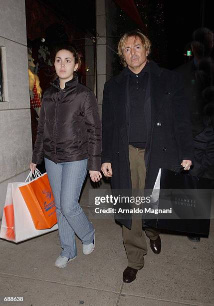 Actor Armand Asante walks with his daughter Ania after shopping at Barneys December 20, 2001 in New York City. Asante was difficult to recognize...