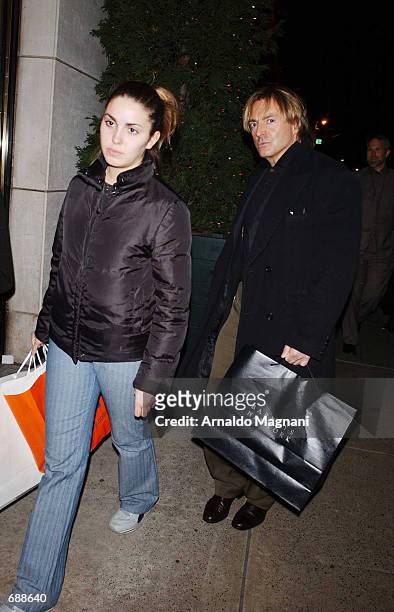 Actor Armand Asante walks with his daughter Ania after shopping at Barneys December 20, 2001 in New York City. Asante was difficult to recognize...