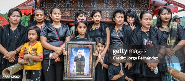 During a traditional ritual funeral of the Tana Toraja. After a few days of funeral celebrations, animal sacrifices and feasts, the day comes to...