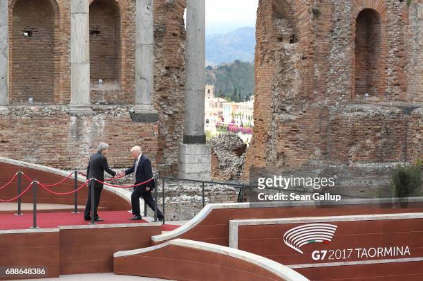 Italian Prime Minister Paolo Gentiloni greets U.S. President Donald Trump in the ancient amphiteater at the G7 Taormina summit on the island of...