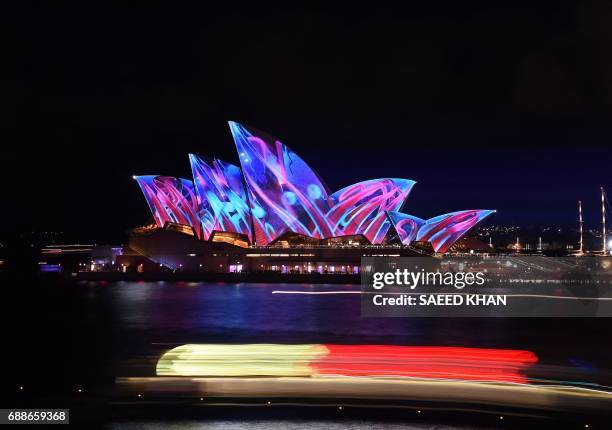 Light show called "Vivid" changes the appearance of the Sydney Opera House in Sydney on May 26, 2017. "Vivid" is a major outdoor cultural event...