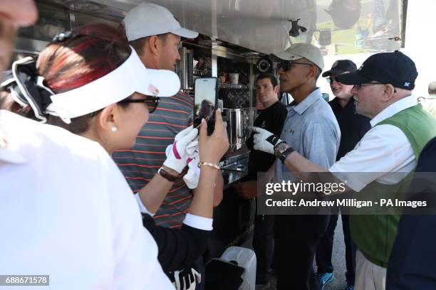 Sir Tom Hunter and former US president Barack Obama stop at a snack bar while playing a round of golf at the Old Course in St Andrews, Fife.