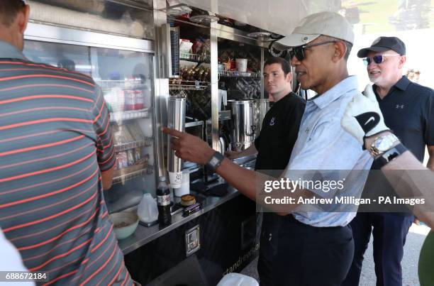 Sir Tom Hunter and former US president Barack Obama stop at a snack bar while playing a round of golf at the Old Course in St Andrews, Fife.