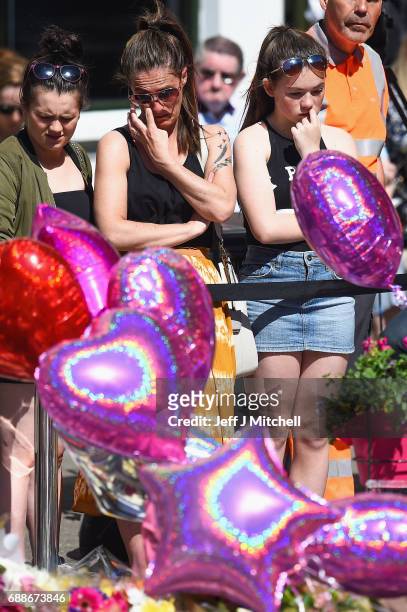 Members of the public look at tributes left for the people who died in Monday's terror attack at the Manchester Arena on May 26, 2017 in Manchester,...