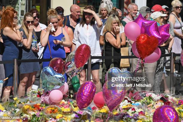 Members of the public look at tributes left for the people who died in Monday's terror attack at the Manchester Arena on May 26, 2017 in Manchester,...