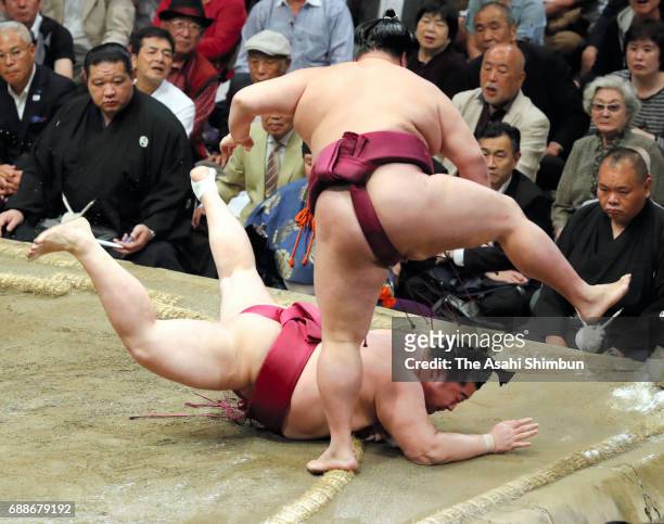 Komusubi Mitakeumi throws Endo to win during day thirteen of the Grand Sumo Summer Tournament at Ryogoku Kokugikan on May 26, 2017 in Tokyo, Japan.