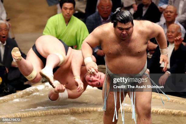 Sekiwake Takayasu throws Mongolian yokozuna Harumafuji to win during day thirteen of the Grand Sumo Summer Tournament at Ryogoku Kokugikan on May 26,...