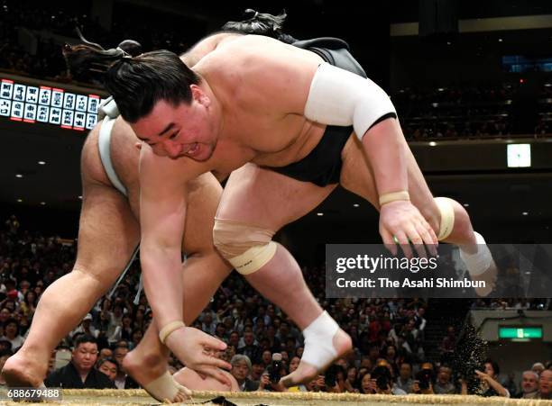 Sekiwake Takayasu throws Mongolian yokozuna Harumafuji to win during day thirteen of the Grand Sumo Summer Tournament at Ryogoku Kokugikan on May 26,...