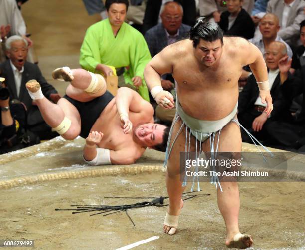 Sekiwake Takayasu throws Mongolian yokozuna Harumafuji to win during day thirteen of the Grand Sumo Summer Tournament at Ryogoku Kokugikan on May 26,...