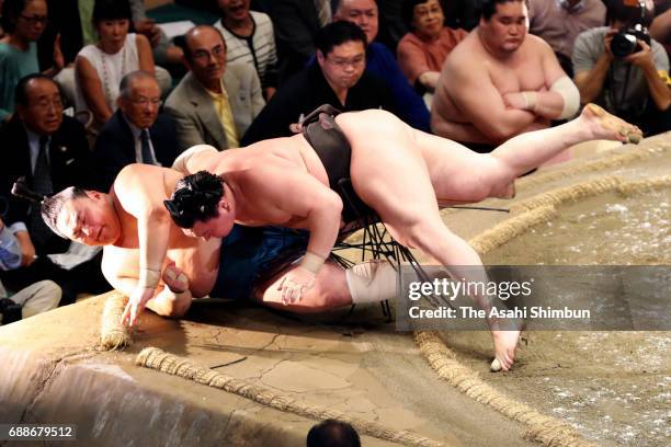 Mongolian yokozuna Hakuho throws Mongolian sekiwake Tamawashi to win during day thirteen of the Grand Sumo Summer Tournament at Ryogoku Kokugikan on...