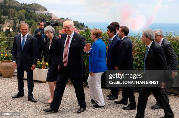 President Donald Trump waves along with European Council President Donald Tusk, Britains Prime Minister Theresa May, German Chancellor Angela Merkel,...