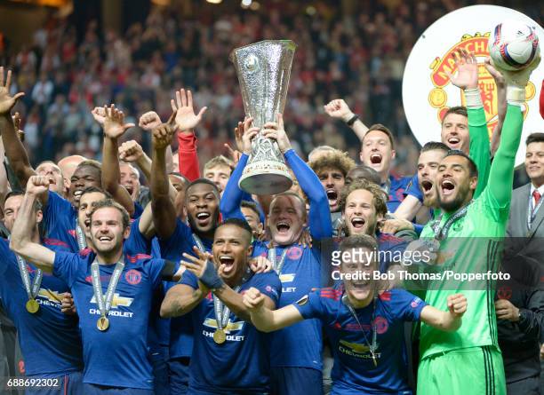 Captain Wayne Rooney holds aloft the trophy and celebrates with the Manchester United team after the UEFA Europa League final between Ajax and...