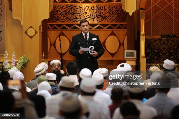 Greater Manchester Police Superintendent David Pester gives an address to worshipers at Friday prayers at Manchester Central Park Mosque on May 26,...