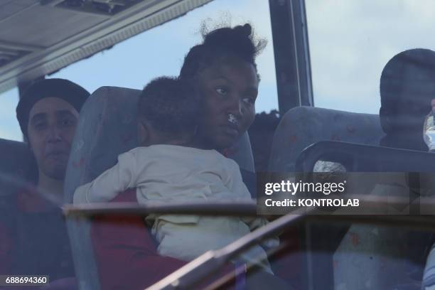 Mom with her baby on autobus after landing from the Ship, Acquarius, of Italian-Franco-German humanitarian organization «Sos Mediterranee» in...