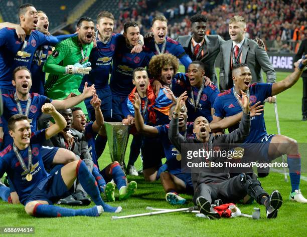 Manchester United team celebrate with the trophy after the UEFA Europa League final between Ajax and Manchester United at the Friends Arena on May...
