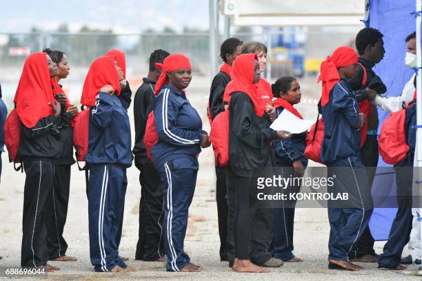 Some young women ready for medical check during the landing of migrants from Vos Hestia ship in the port of Corigliano, Calabria, southern Italy. The...