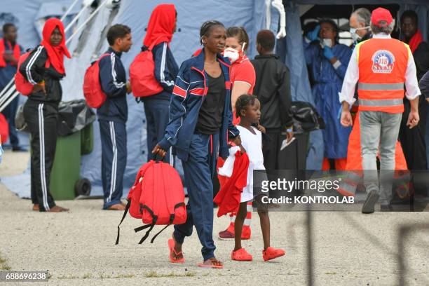 Mom with her child during the landing of migrants from Vos Hestia ship in the port of Corigliano, Calabria, southern Italy. The refugees are 635 of...