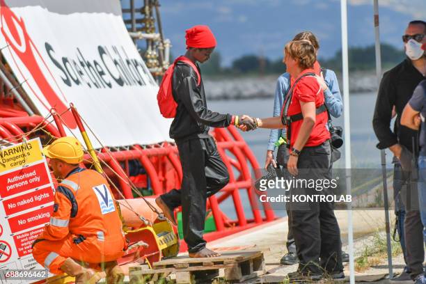 Young migrant greets a Save the Children operator during the landing of migrants from Vos Hestia ship in the port of Corigliano, Calabria, southern...