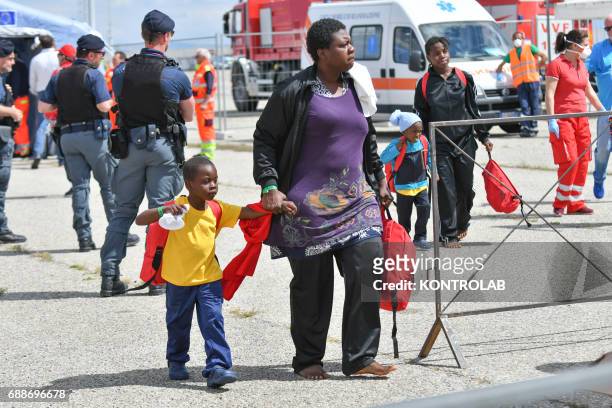 Mom with her child during the landing of migrants from Vos Hestia ship in the port of Corigliano, Calabria, southern Italy. The refugees are 635 of...