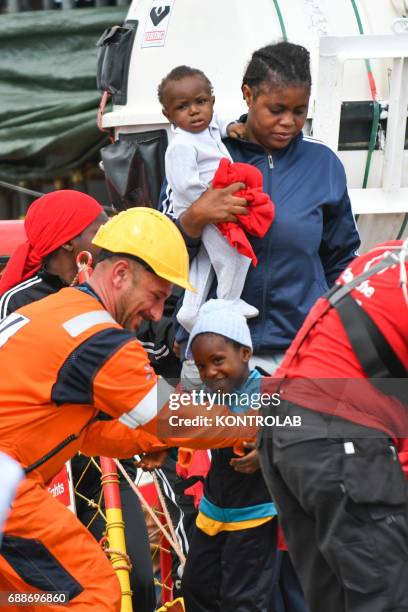 Mom with two children during the landing of migrants from Vos Hestia ship in the port of Corigliano, Calabria, southern Italy. The refugees are 635...