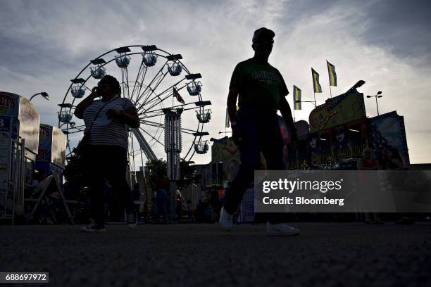 Visitors walk through the Dreamland Amusements carnival in the parking lot of the Marley Station Mall in Glen Burnie, Maryland, U.S., on Friday,...