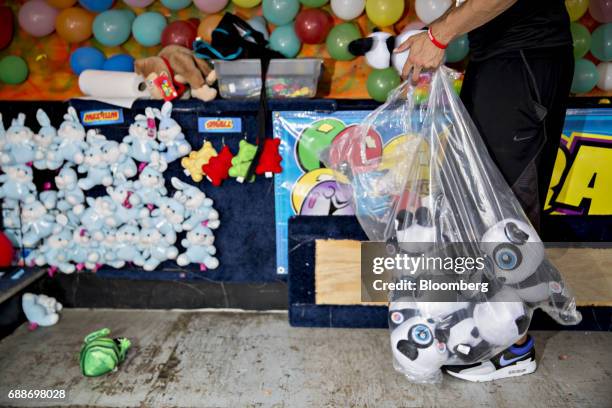 Game operator prepares his booth during the Dreamland Amusements carnival in the parking lot of the Marley Station Mall in Glen Burnie, Maryland,...