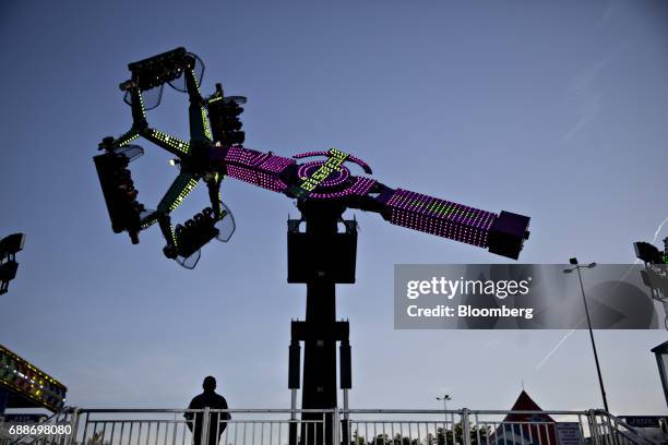 An operator watches as the Delusion ride operates during the Dreamland Amusements carnival in the parking lot of the Marley Station Mall in Glen...