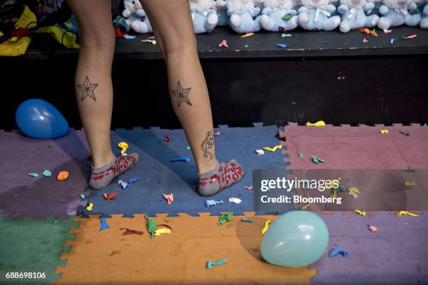 Game operator stands in the Balloon Burst booth during the Dreamland Amusements carnival in the parking lot of the Neshaminy Mall in Bensalem,...