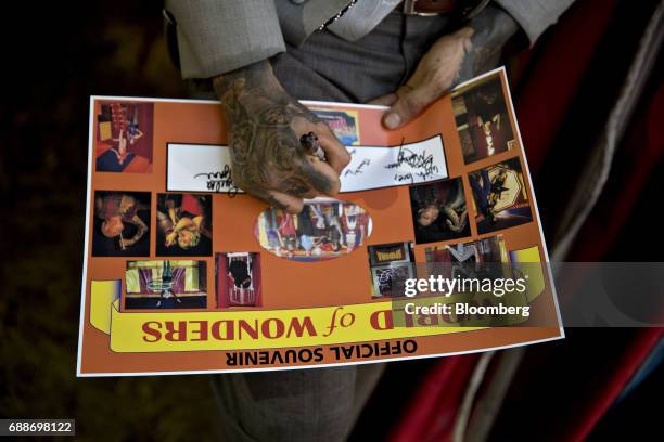 Showman signs a souvenir poster in the World of Wonders tent during the Dreamland Amusements carnival in the parking lot of the Neshaminy Mall in...