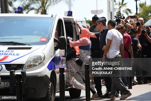Woman enters a Police van after being arrested by Police on May 26, 2017 outside the luxury Martinez hotel, before she attempted with other women to...