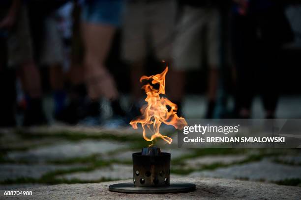 People visit the Eternal Flame at the grave of assassinated former US President John F. Kennedy near the 100th anniversary of his birth at Arlington...