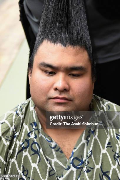 Sekiwake Takayasu responds a question while having his topknot arranged after his victory over Mongolian yokozuna Harumafuji in the dressing room...