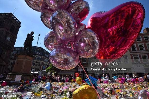 Flowers and balloons are left in Saint Ann's Square in tribute to those killed in an explosion at the Manchester Arena earlier this week on May 26,...