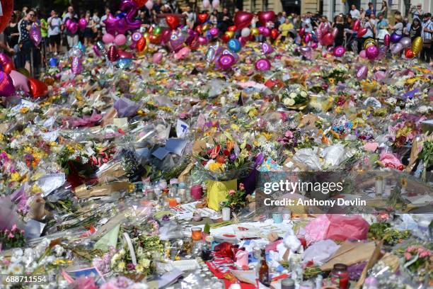 Flowers and balloons are left in Saint Ann's Square in tribute to those killed in an explosion at the Manchester Arena earlier this week on May 26,...