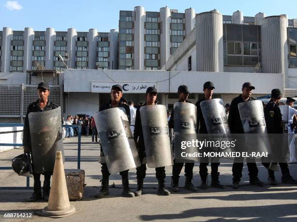 Egyptian police stand guard outside a hospital in Cairo's northern suburb of Shubra on May 26 following an attack in which 28 Coptic pilgirms were...