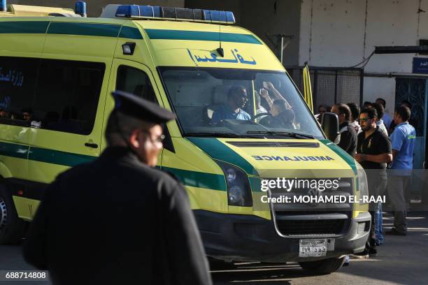 An ambulance transporting wounded Egyptians arrives at a hospital in Cairo's northern suburb of Shubra on May 26 following an attack in which 28...