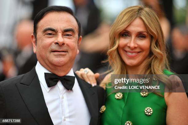 Renault CEO Carlos Ghosn and his wife Carole Ghosn arrive on May 26, 2017 for the screening of the film 'L'Amant Double' at the 70th edition of the...