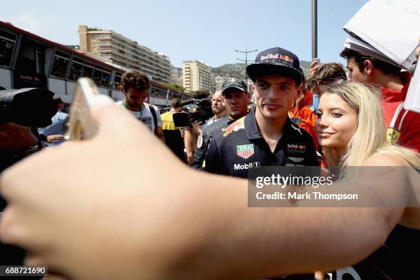 Max Verstappen of Netherlands and Red Bull Racing poses for a photo with a fan during previews to the Monaco Formula One Grand Prix at Circuit de...